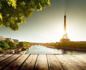 background with wooden deck table and  Eiffel tower in Paris
