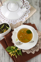 Cup of tea with linden on napkins on    wooden table