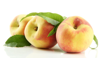 Ripe sweet peaches with leaves, isolated on white