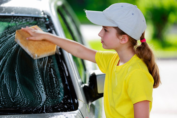 Carwash - young girl helping in carwash - Powered by Adobe