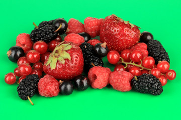 Ripe berries on green background