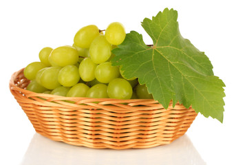 Ripe delicious grapes in wicker basket isolated on white