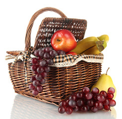 Picnic basket with fruits isolated on white