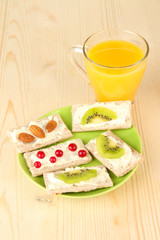 Tasty canapes with cheese, kiwi and cranberry, almond,