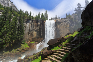 Vernal Falls with view on granite steps on mist trail to the top of 317-foot waterfall, Yosemite...
