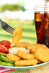 Fried chicken nuggets with vegetables,cola and sauce