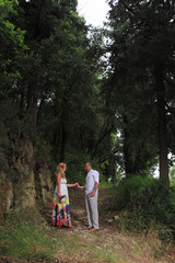 portrait of a young couple walking in the forest