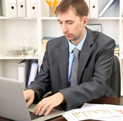 Young businessman in office at his workplace