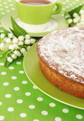Delicious poppy seed cake with cup of tea on table close-up