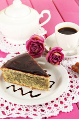 Delicious poppy seed cake with cup of coffee on table close-up