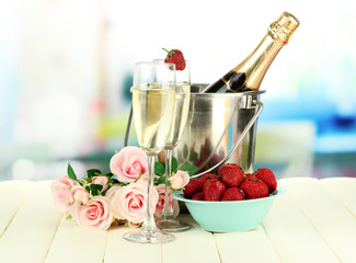 Romantic still life with champagne, strawberry and pink roses,