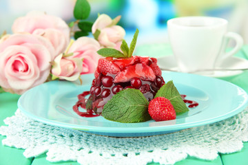 Tasty jelly dessert with fresh berries, on bright background