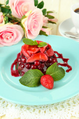 Tasty jelly dessert with fresh berries, on bright background