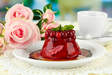 Tasty jelly dessert with fresh berries, on bright background