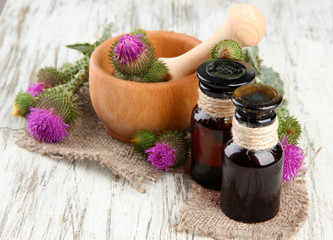 Medicine bottles and mortar with thistle flowers