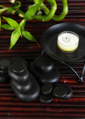 Spa stones and bamboo on bamboo mat background