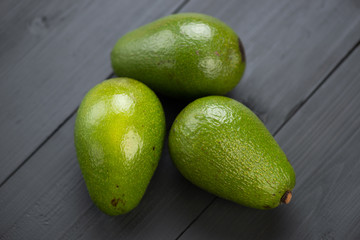 Fruits: avocados on black wooden boards