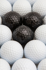 White and black golf balls in the box