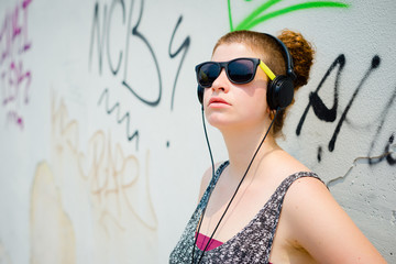 beautiful stylish modern young woman listening to music