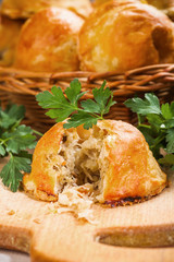 Baked bread stuffed with cabbage and mushrooms on board