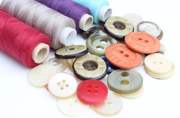 Colored buttons with colorful spools of thread