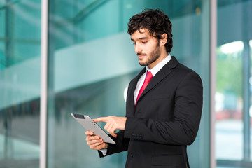 Young businessman using a tablet