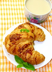 Croissant with cup of white coffee