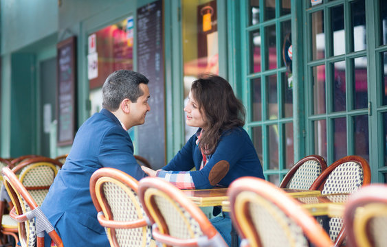 Couple discussing something in an outdoor cafe