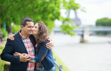 Happy couple kissing near the Seine