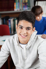 Teenage Schoolboy Sitting In Library