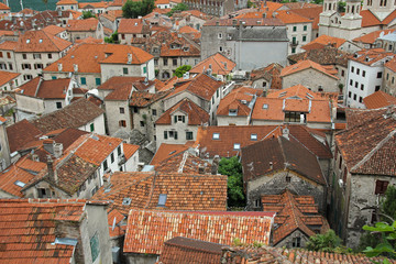 Fototapeta na wymiar red tiled roofs of the buildings in old town of Kotor