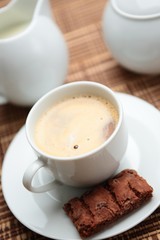 Cup of coffee served with a cookie