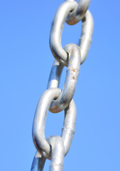 Chain Links - Shows a closeup of a metal chain link segment from