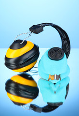 Respirator and headphones on blue background