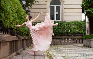Young beautiful ballerina posing outdoor