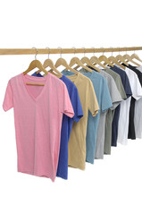 man clothes of different colors shirt on wooden hangers