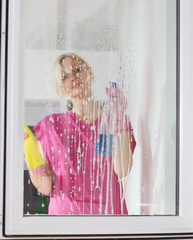 woman washing the window glass