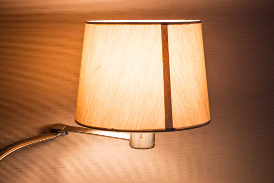 Turned on work table lamp in room