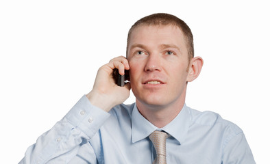 Businessman listening closely to caller against a white