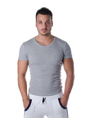 Obraz premium Handsome and fit young man standing on white background