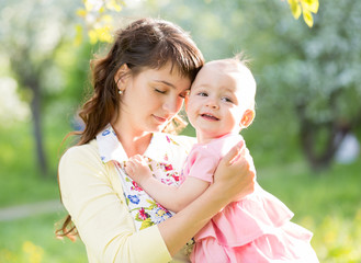 loving mother with baby girl outdoors