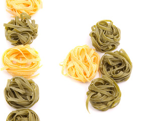 Yellow and green uncooked tagliatelle