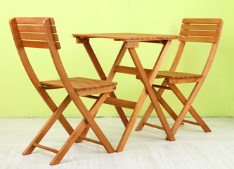 Wooden table with chairs in room