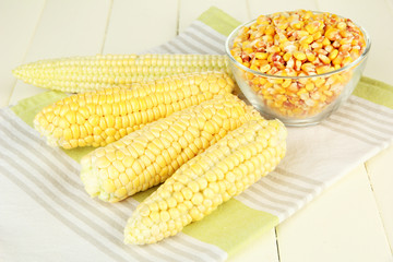 Fresh and dried corn on wooden background