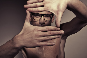 Portrait of man making a square by hands