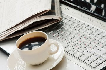 Obraz na płótnie Canvas Cup of fragrant coffee on a morning paper