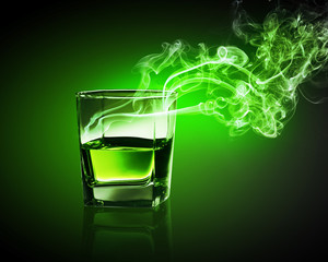 Glass of green absinth