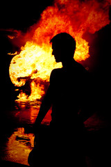 Silhouette of a male fireman, fire, jet plane on fire