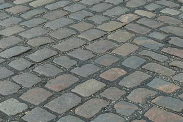 Fototapeta premium Old cobbled stone road running diagonally.