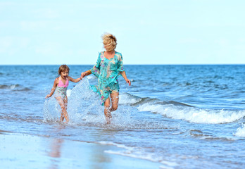 Mother with daughter on beach